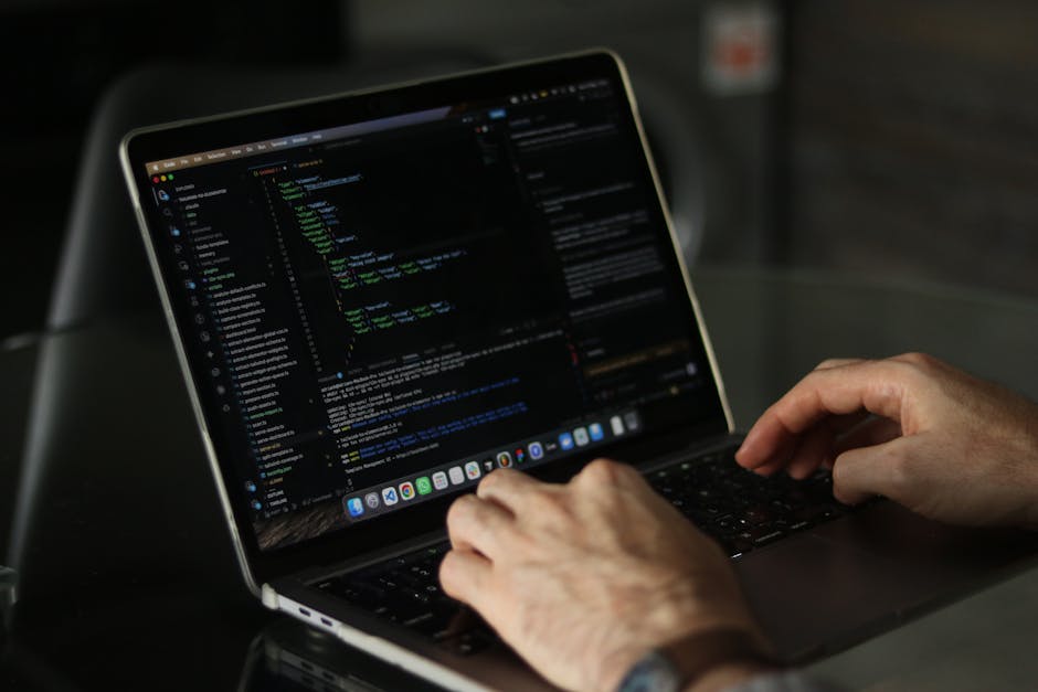 A detailed close-up of a computer screen displaying lines of HTML and coding text in various colors, including tags, attributes, and inline comments, with some parts slightly blurred due to focus. The